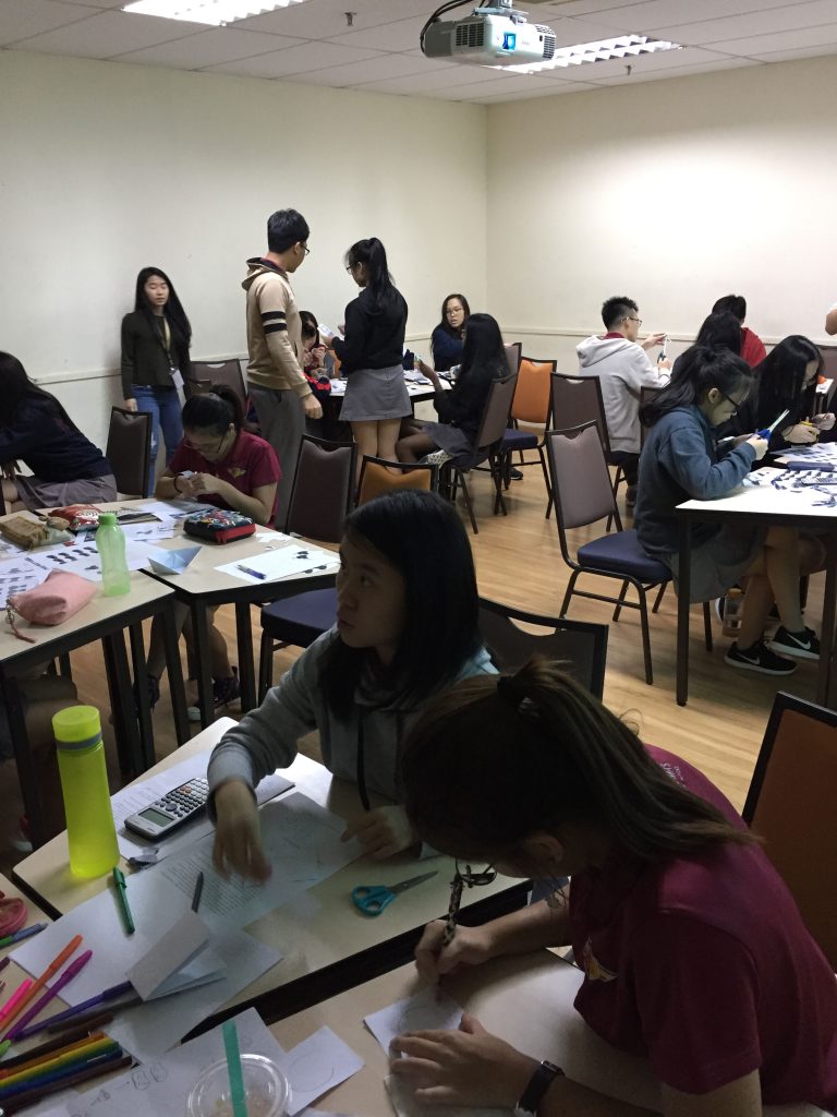 Sri Emas International School Upper secondary students using experiential learning in Economics class to learn about economic principles.